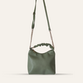 Green handbag with chain strap on a white background