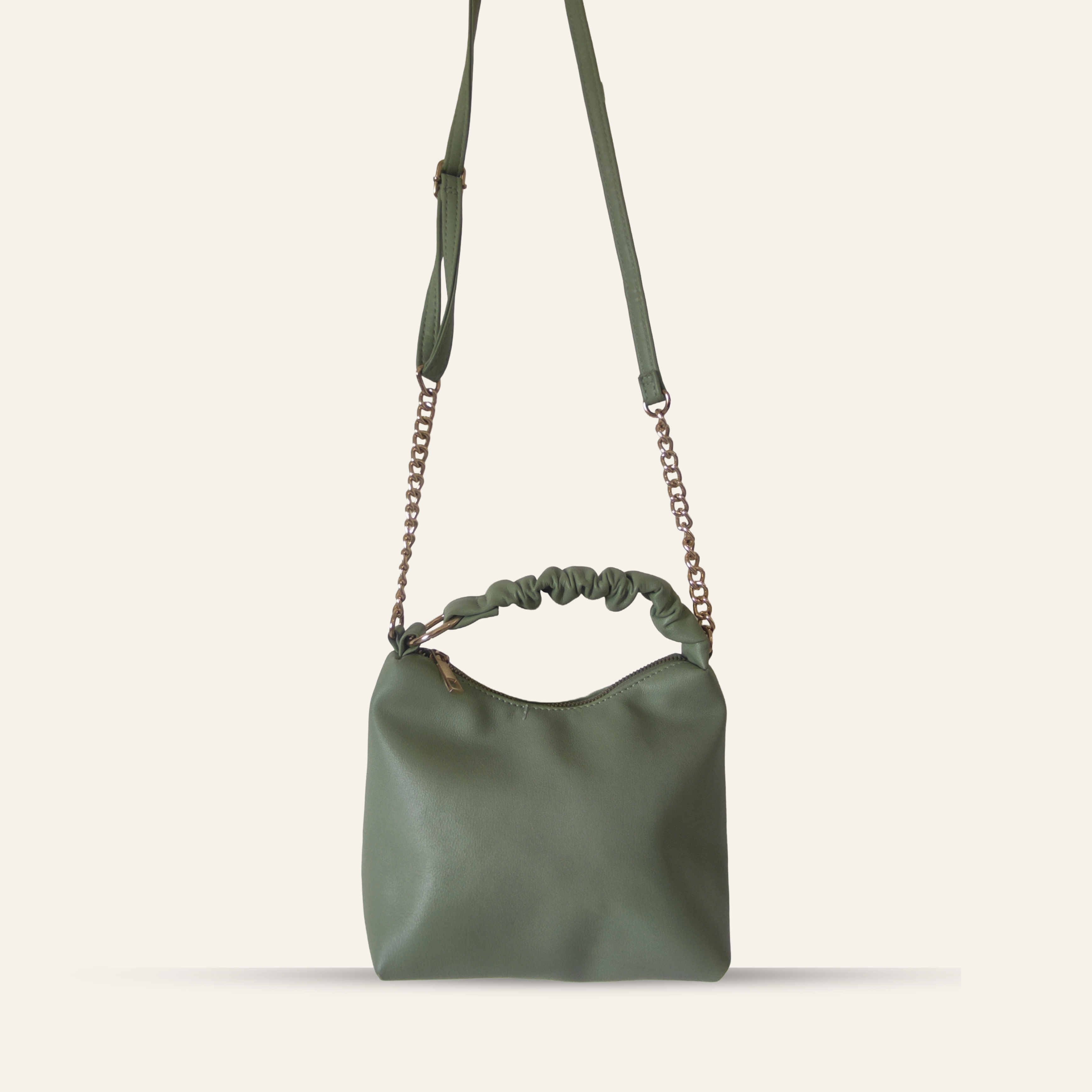 Green handbag with chain strap on a white background
